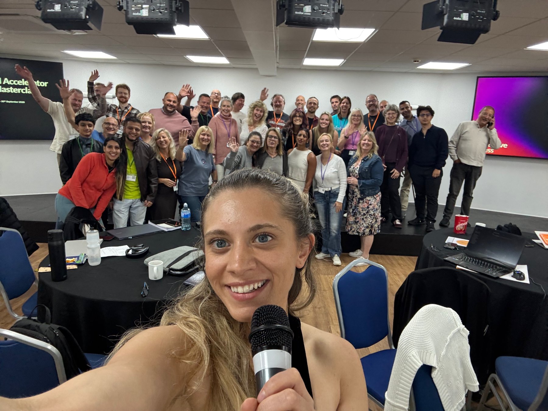 Sabrina on the mic in front of a full room